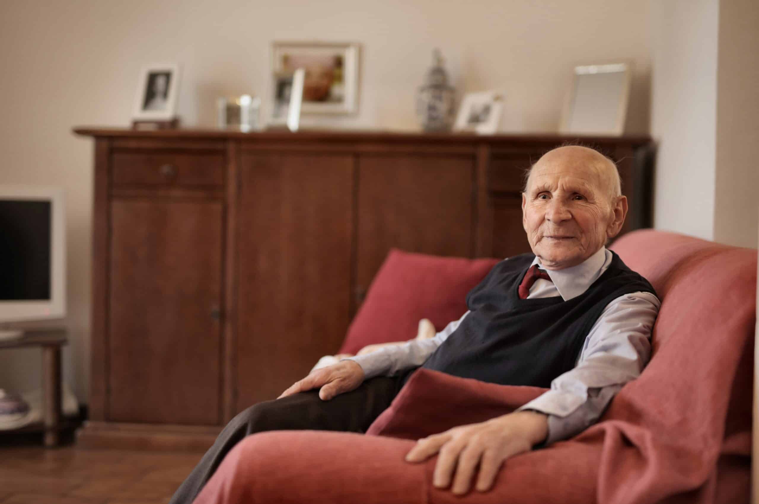 Elderly man sitting in his own home by himself